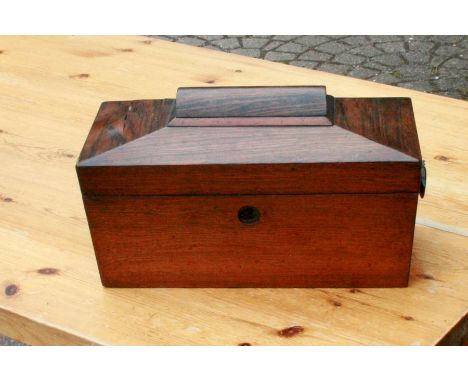 An early Victorian rosewood tea caddy, circa 1850, in a sarcophagus form, hinge lid enclosing a mixing jar and silver plated 