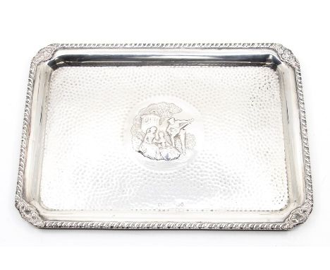 A late Victorian silver tray, beaded edge, the central motif depicting a young man playing a Balalaika to two young women, su