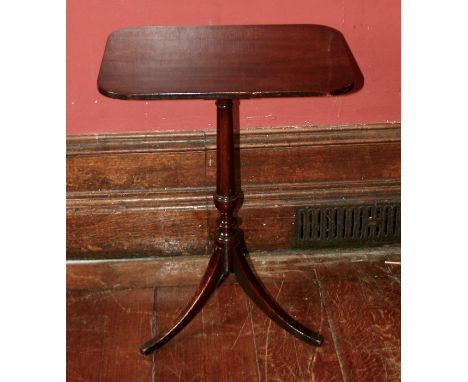 An early to mid 19th century mahogany tripod occasional table, rectangular top with rounded edges, raised on a turned column 