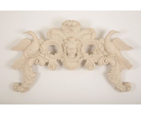 A CARVED WOOD ARCHITECTURAL PEDIMENT of Georgian style, with central cherub head amongst scrolling acanthus leaves and flanke