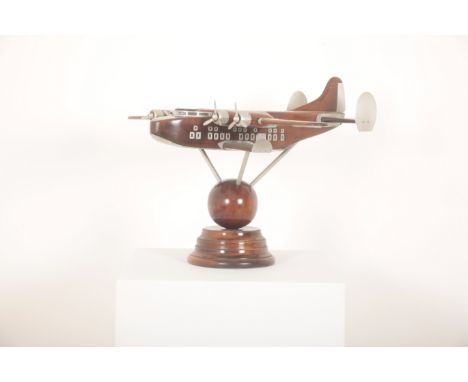 A WOODEN MODEL OR DESK ORNAMENT OF A SEA PLANE OR FLYING BOATmodern, realistically crafted with four revolving metal propelle