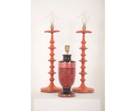 A PAIR OF ORANGE PAINTED METAL OR 'TOLEWARE' LAMPS with shaped baluster stems, 56cm high (to top of stem); together with oran