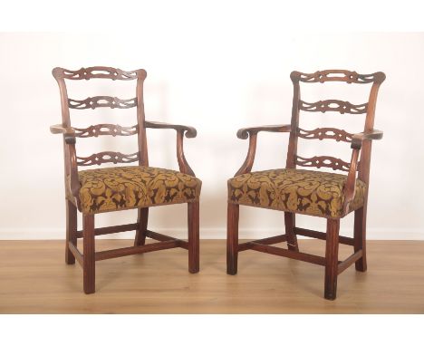 A PAIR OF GEORGE III MAHOGANY OPEN ARMCHAIRSof Chippendale style, with pierced shaped ladder backs, scrolled arm terminals, s