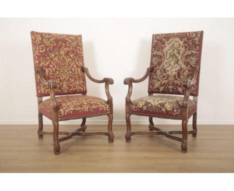 A PAIR OF WALNUT ARMCHAIRS IN WILLIAM AND MARY STYLEboth with tapestry covers, one with a heraldic beast to the back, with br