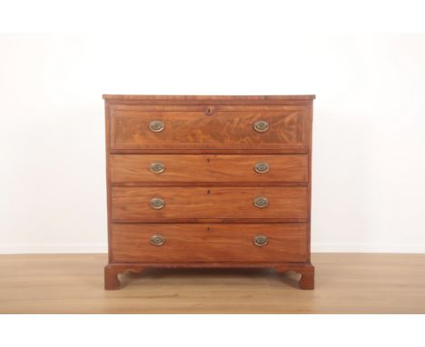 A GEORGE III MAHOGANY SECRETAIRE CHEST mid-19th century, the front fall enclosing pigeonholes and eight small drawers with iv