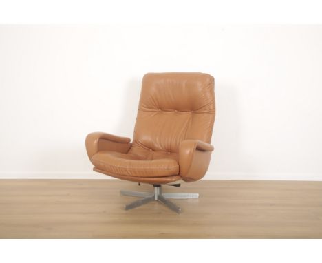 A SWIVEL OFFICE CHAIR MODEL DS231 BY DE SEDE mid-20th century, Swiss, tan leather with shaped arms and chrome pivoting star b