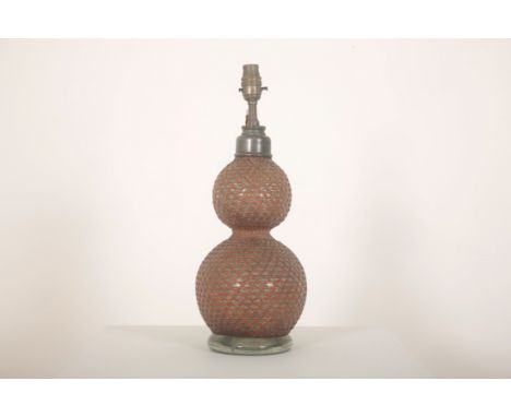 A CONVERTED GLASS SODA SYPHON TABLE LAMP 19th century and later, French, the double gourd shape encased in wicker cage, stamp