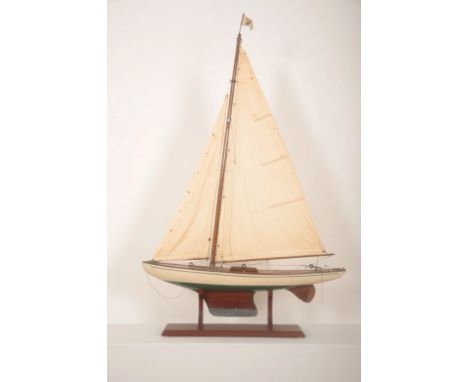 A MODEL POND YACHT WITH STANDearly 20th century, 120cm high (to top of flag and including base) x 90cm long x 16cm wideProven
