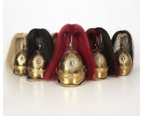 SEVEN MODEL BRASS CAVALRY HELMETS WITH HORSEHAIR PLUMES British Victorian 1871 Pattern style but later, all numbered on their