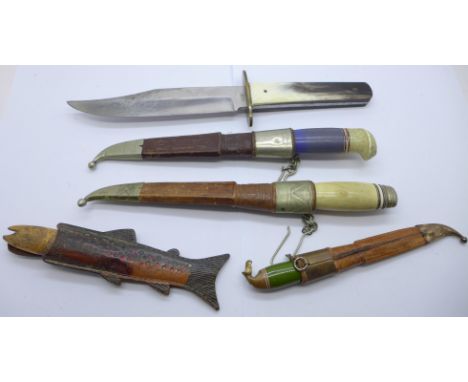 Three Finnish Puuko knives with scabbards, one other knife with fish handle and scabbard, the scabbard marked Norge and a hun