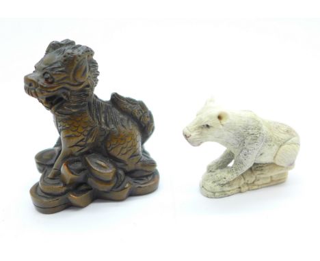 A signed Kirin netsuke and a carved lion, lion a/f 