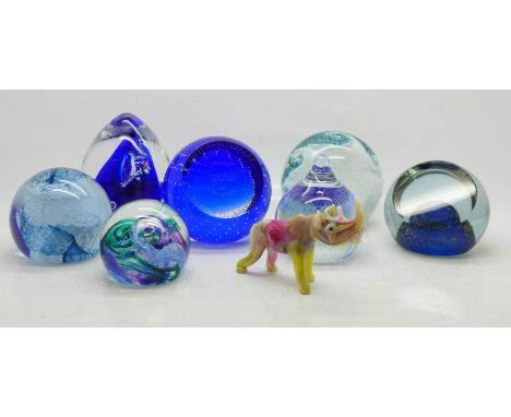 A collection of glass paperweights including Caithness and a small glass rhinoceros 