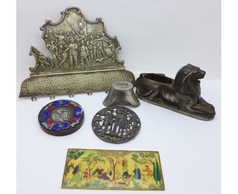 A painted faux ivory plaque, a metal lion pin cushion, Chinese weight, etc. 