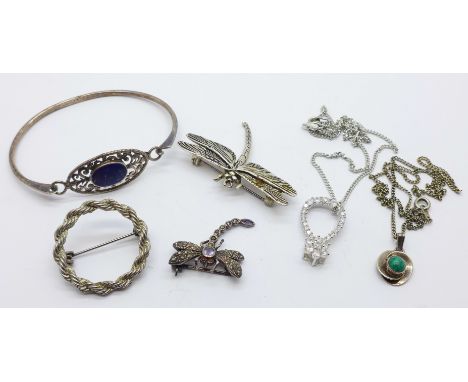 An 800 silver and stone set dragonfly brooch, one other dragonfly brooch, a silver bangle, two silver pendants, etc. 
