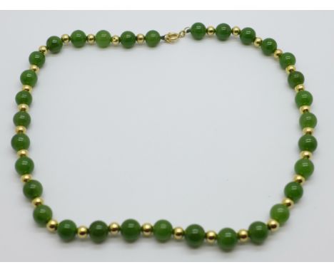 A jade and yellow metal necklace, the fastener marked 585, 41cm 