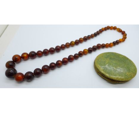 A Kigu shagreen compact and a necklace 