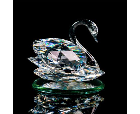 Lead clear crystal figure part of the Feathered Beauties. Modeled as a delicate swan swimming gracefully. Swarovski etched ba