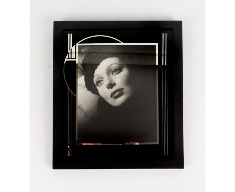 High quality photographic print depicting a portrait of American actress Loretta Young wearing a black hat and lying her head