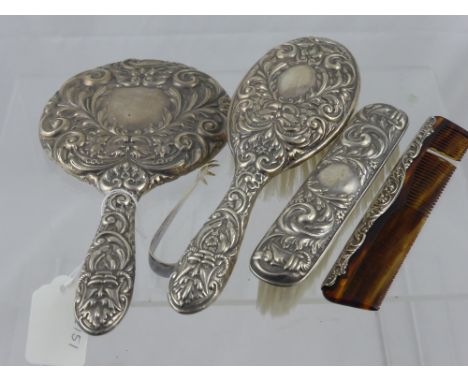 A solid silver dressing table set comprising hair and clothes brushes, mirror and comb, Birmingham hallmark