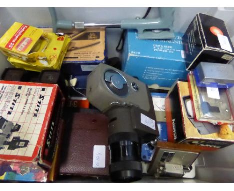 A Box of Camera Flashes and light filters together with a large varied selection of camera lenses. 