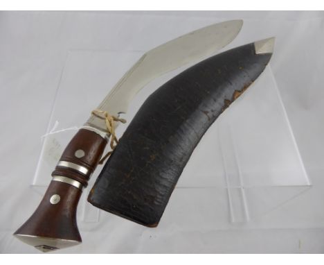 An Antique Chrome Bladed Khukuri Knife. The knife with leather covered sheath and having chrome banded handle and pommel, bla
