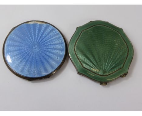 Two Vintage Ladies Compacts, with decorative enamel tops of green and blue together with a child's bone rattle. 