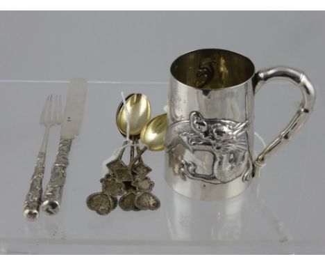 A Solid Silver Chinese Christening Mug, depicting a chasing dragon approx 160 gms,   together with a Christening knife and fo
