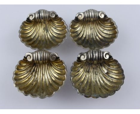 Four Shell Form Silver Salt Cellars, Birmingham hallmark 1907,a pair of silver sugar nips together with a pair of solid silve