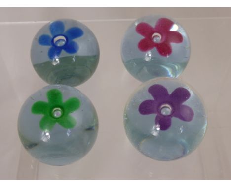 Four Caithness Pop Flower Paperweights, including Purple, Blue, Green and Pink.