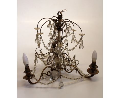 An early 20th century brass three light electrolier with lustre swags and drops. 60 x 55cm approximately