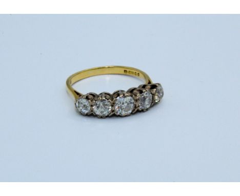A five stone diamond ring set with five graduated round old mine cut diamonds, to an estimated weight of 1.30 carats. Set in 