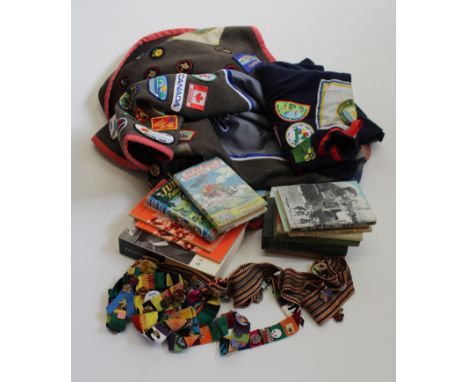 A Girl Guide wool blanket, decorated with many dozens of cloth jamboree and camp badges, circa 1950's to 2010, 245 x 215cm, t