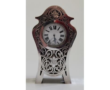 Lawrence Emanuel, an Edwardian silver reticulated serpentine mantle clock case, with silver wedding presentation inscription,
