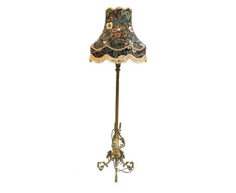 A Brass Standard Lamp, on lion mask and scroll supports, 174cm including shade