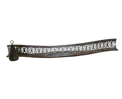 A George III Pierced Steel Fender, with foliate decoration, 145cm, together with an agate door stop with brass fitted handle