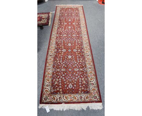 Hereke Wool Runner, the burgundy floral field enclosed by ivory borders of meandering vines, flanked by guard stripes, 303cm 