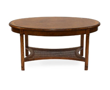 A Reproduction Crossbanded Burr Walnut Oval Coffee Table, with waisted caned shelf stretcher, 106cm by 78cm by 51cm