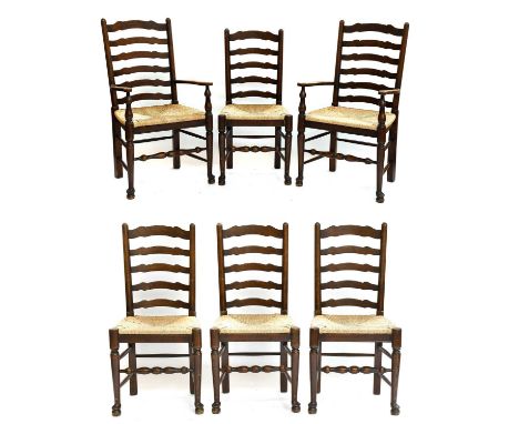 A Set of Six Oak Ladder Back Dining Chairs, including two carvers with rushed seats