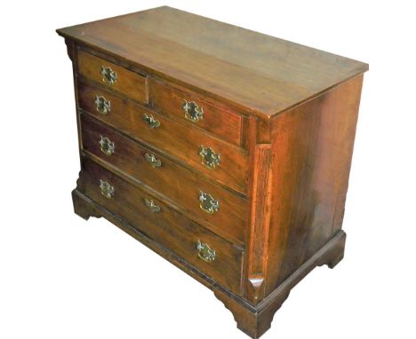 A George III mahogany chest of drawers, the top with a moulded border, above two short over three long drawers, each with bra