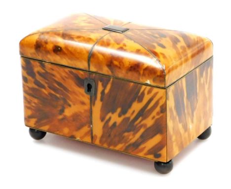 A Regency blonde tortoiseshell tea caddy, of domed twin division form, with a cartouche engraved M Swallow, fitted part foil 