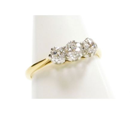 A diamond three stone ring, brilliant cut in a claw setting, white and yellow metal, stamped 18ct plat, approx 0.5cts, size K