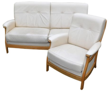 An Ercol cream leather and elm two seater sofa, and a matching armchair. 