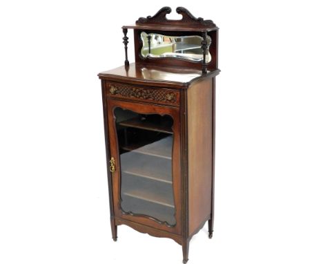 An Edwardian mahogany music cabinet, the raised back with swan neck pediment above a shelf, with moulded edge and a bevelled 