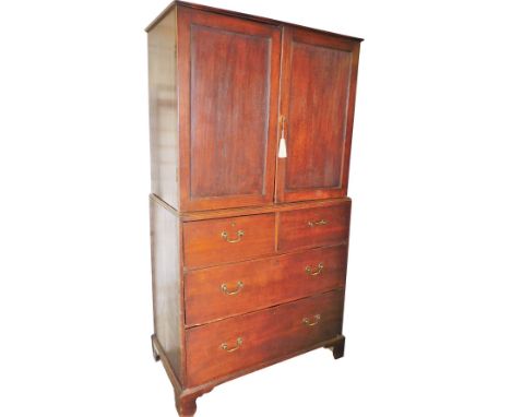 A George III oak linen press, the upper section with fitted drawers raised above two short over two long drawers, on ogee bra