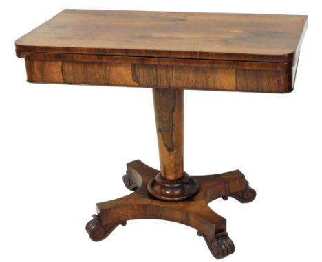 A William IV rosewood card table, the rectangular fold over top with rounded corners enclosing a baize lined interior, on a c