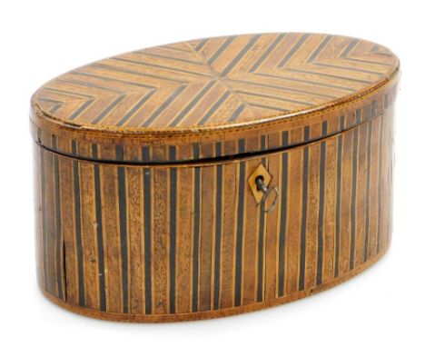 An early 19thC oval boxwood ebony and mahogany tea caddy, with chequer banded borders, the hinged lid enclosing a vacant inte