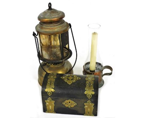 A Victorian ebony dome top jewellery casket, with brass mounts, a Tilley style lamp, and a small brass chamber candlestick (A