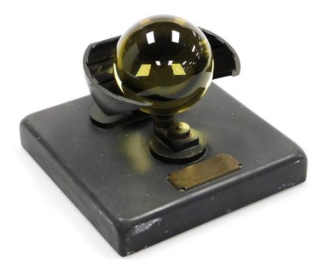 A Campbell Stokes sunshine recorder, with bronzed metal mounts, on a black slate base, mounted with a plaque for the maker, L