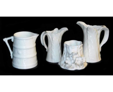 A Royal Worcester white glazed porcelain cream jug, moulded to simulate a barrel, two Worcester cabbage leaf jugs, and a smal