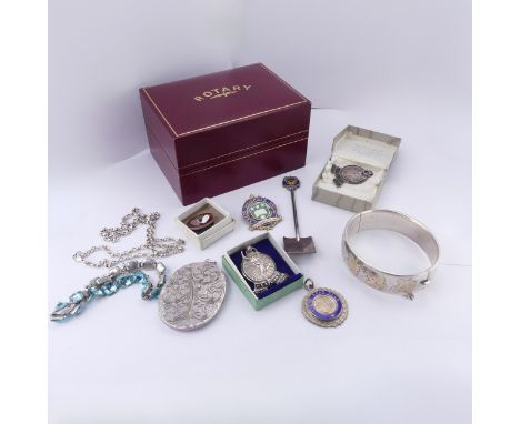 A silver hinged Bangle, with gilt foliate decoration, together with a quantity of silver prize fobs and medallions, an oval s